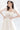 Близък кадър на корсета с вградени чашки и фини метални банели от LIZA KAIN bridal. Горната част е обшита с дантела, която покрива презрамките и е декорирана с ръчно нашити 3D цветя за триизмерен финес. Дизайнът перфектно подчертава и оформя силуета.
