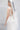  Ivy Embrace от LIZA KAIN bridal, изработена от телесен тюл. Върху него симетрично разцъфтяват богати апликации от бродирани листа и нежни перли, които извайват силуета.