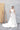 Асиметрична булчинска рокля Emeralda Bohéme от LIZA KAIN bridal с артистична линия и богата флорална дантела. Горната част прелива в пола от висок клас сатен с тежко падаща А-линия. Моделът завършва с фин, елегантен шлейф.