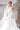Изящна горна част на булчинския модел, Veneris, от LIZA KAIN bridal, показваща красиво оформено деколте, което отваря линията на раменете. Детайлът придава деликатен финес, лекота и романтичен характер на силуета.