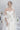 Детайл от издължената линия на корсета Veneris от LIZA KAIN bridal, която прецизно акцентира върху талията. Този елемент създава плавен и изящен преход към обемната долна част.