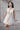 Ефирна къса булчинска рокля Arwen Celestia от LIZA KAIN bridal с деликатно романтично излъчване. Моделът съчетава фина дантелена основа и къс съвременен мини силует, който придава лекота и естествено движение.