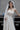 Близък кадър на горната част на сватбената рокля Moonblush от LIZA KAIN bridal, акцентиращ върху изящния драпиран ефект. Дизайнът нежно обгръща бюста, създавайки усещане за артистична мекота и финес.