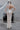 Долната част на сватбената рокля Andromeda Starfall от LIZA KAIN bridal, акцентираща върху високата странична цепка. Този детайл елегантно подчертава крака и добавя красива динамика и движение към визията.