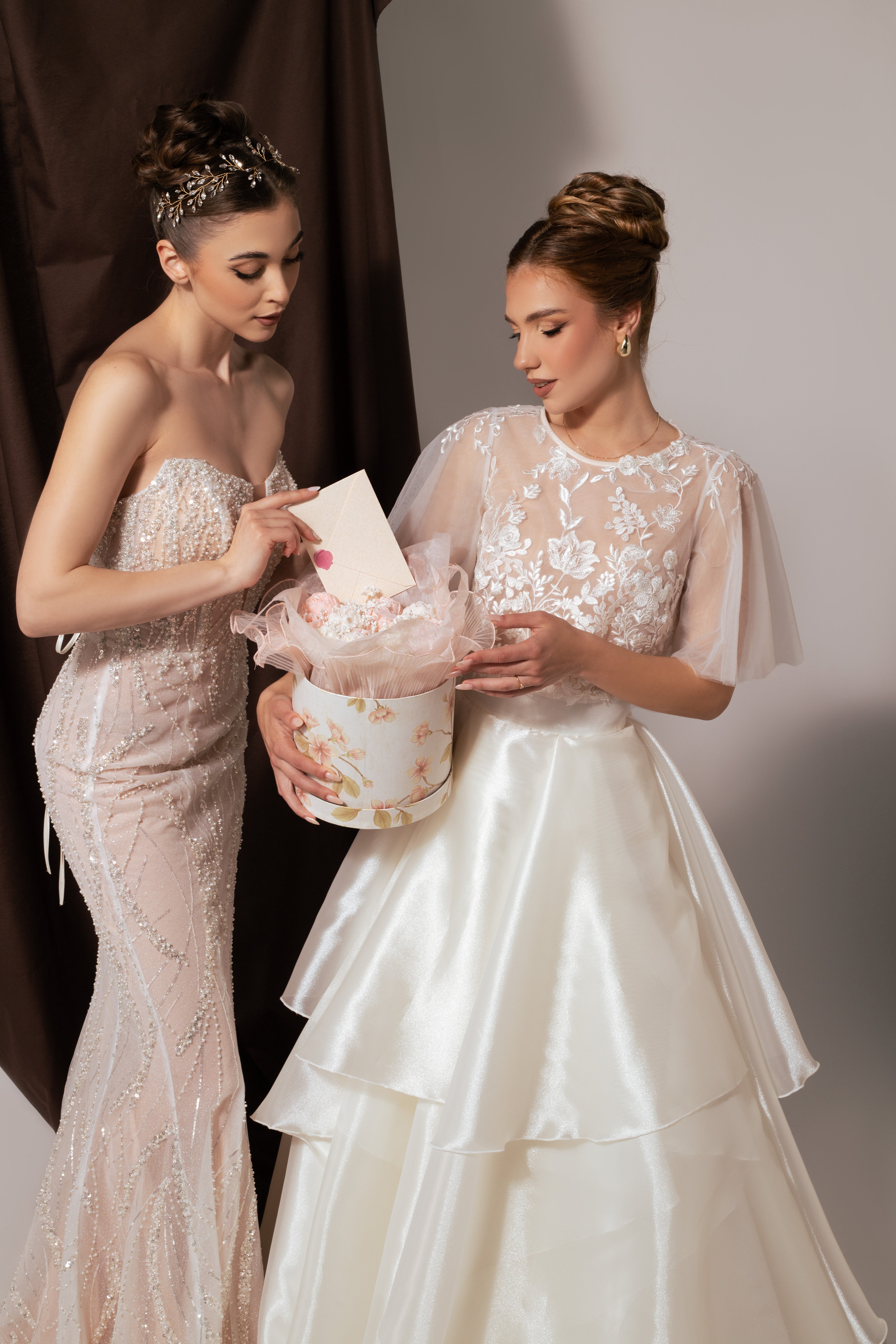 Дълга булчинска рокля Eleanor LIZA KAIN София от две части. Официална бяла рокля. Свободна горна част с ръкави от тюл. Прозрачна основа, покрита с флорална дантела. Обемна пола от органза с колан и воали. 