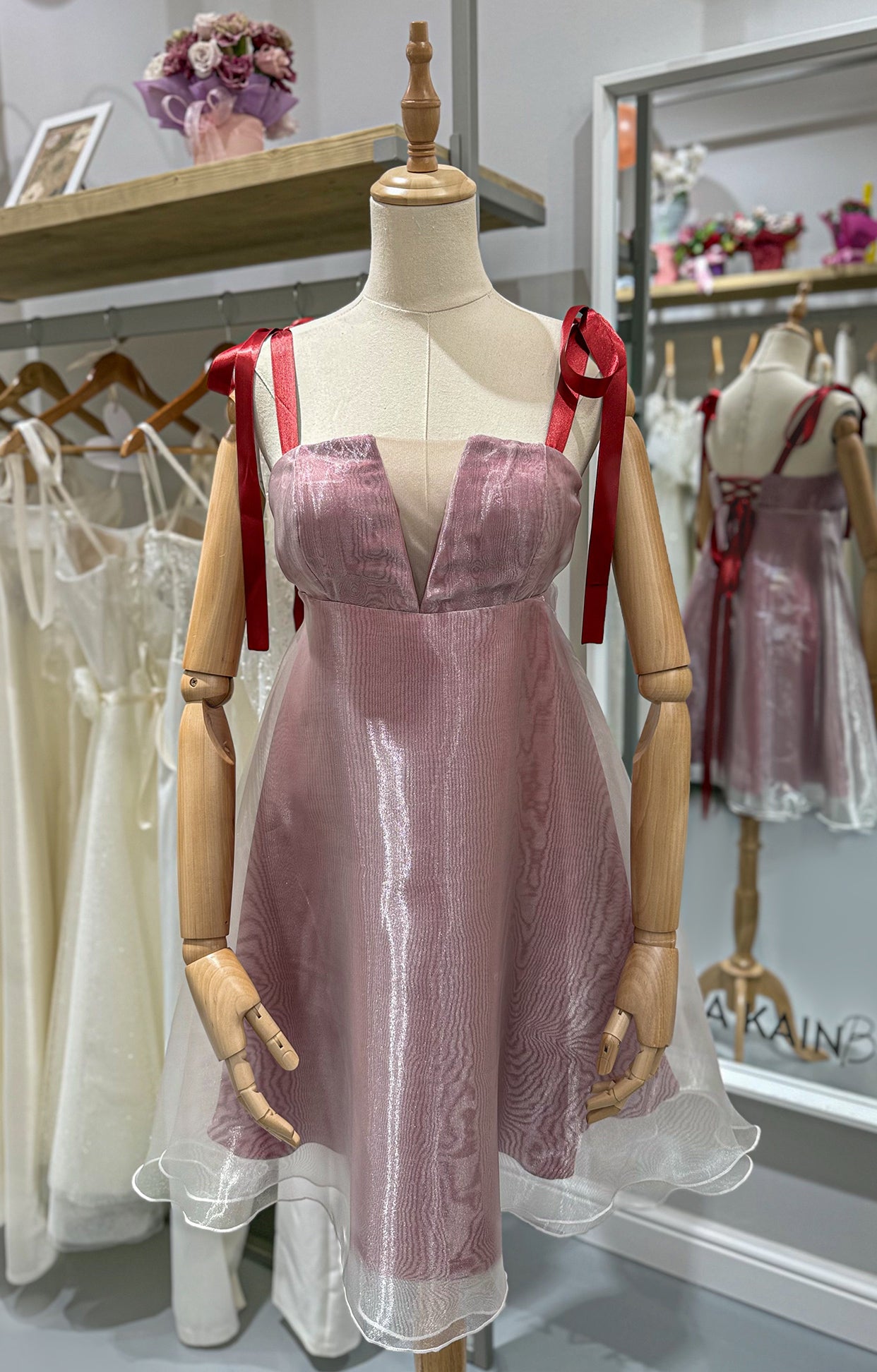 Къса официална рокля Wild Rose LIZA KAIN София. Розова рокля от сатен и органза с равно деколте с мрежа. Червени презрамки тип панделка. Разкройка от подбюст. 