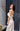 Официален комплект Enchanted Ivy LIZA KAIN София. Булчински комплект от две части. Корсет с прозрачна основа и апликации от цветя с връзки на гърба. Бял сатенен панталон с висока талия, джобове и плохи. Широк панталон.